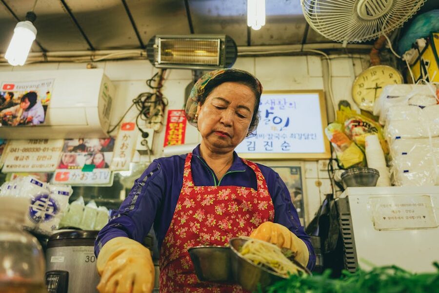 Seoul street food vendor preparing Korean snacks at a market stall