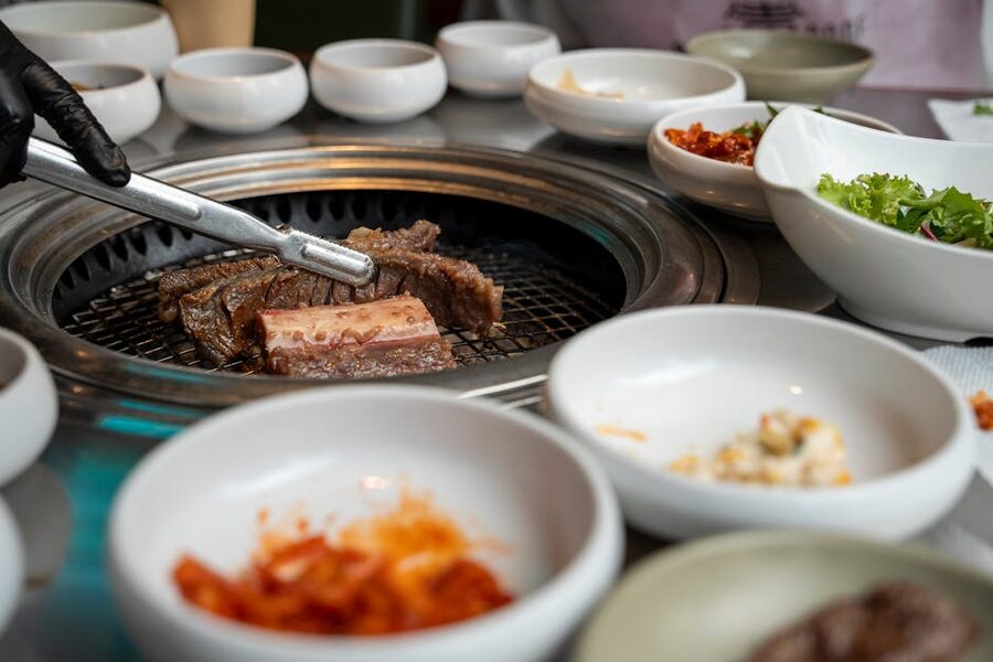 Korean BBQ grill with banchan side dishes