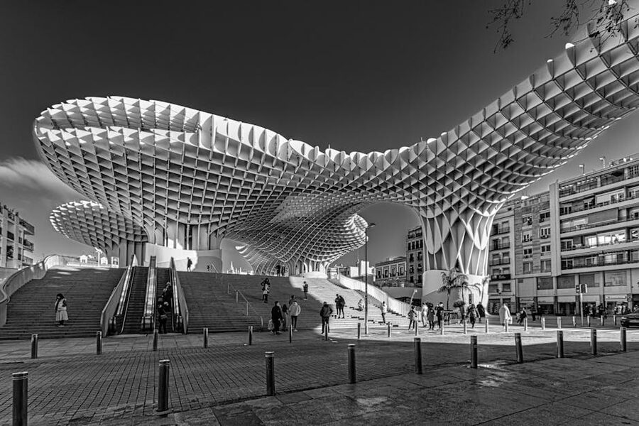 People walking on the Setas de Sevilla rooftop in black and white