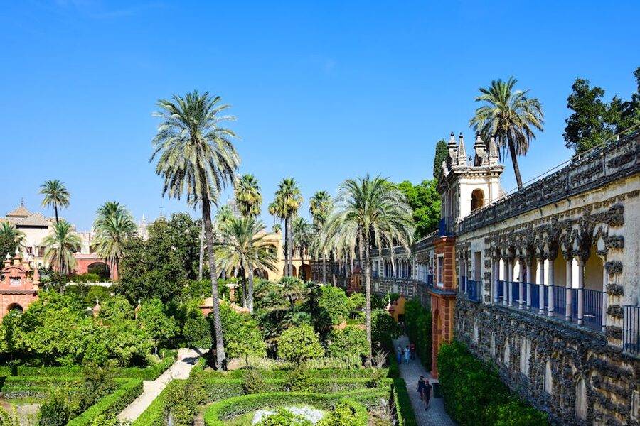 Garden in Seville Alcazar with Moorish arches and palms