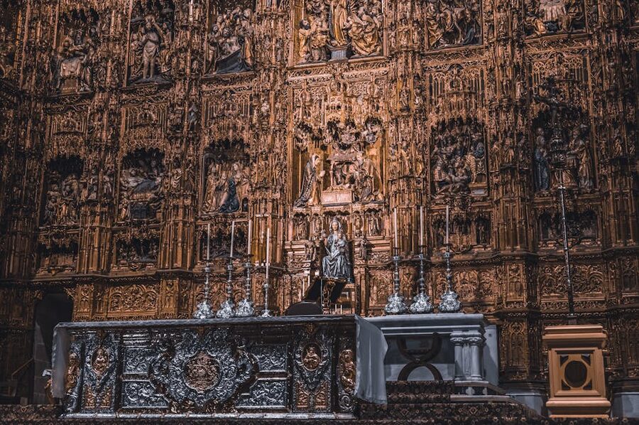 Golden altar of Seville Cathedral with detailed religious carvings