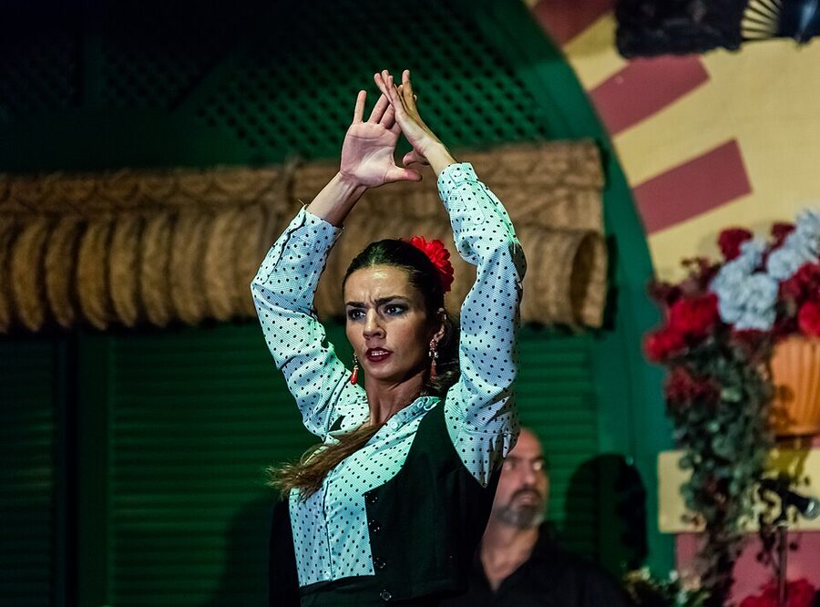 Bailaora flamenco dancer with arms raised, Seville