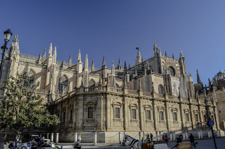 Seville Cathedral with horse-drawn carriage in the historic center