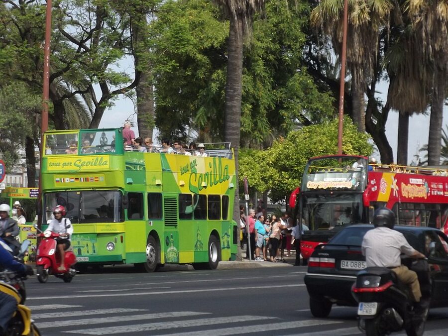 City Sightseeing Seville red double-decker bus on Paseo de Cristobal Colon
