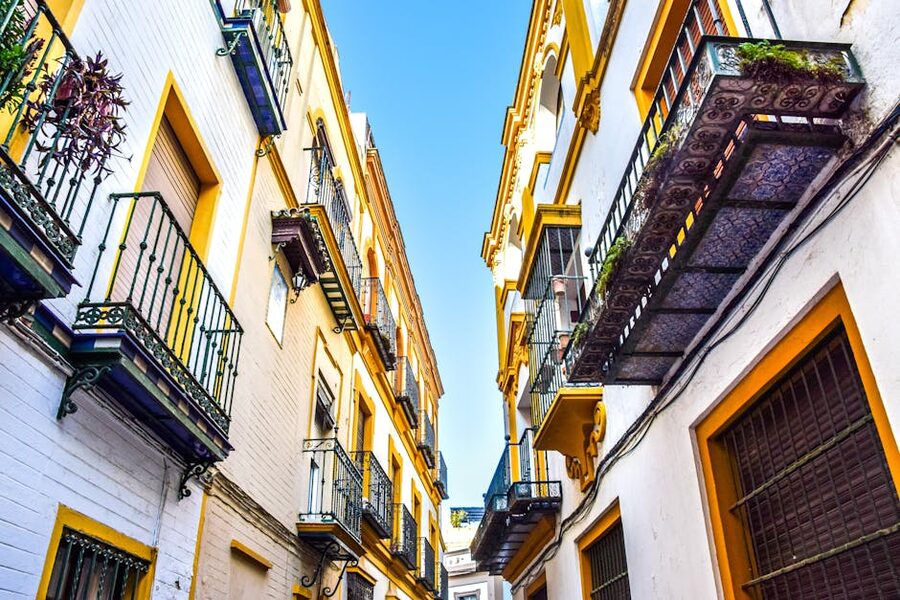 Narrow street with balconies in Santa Cruz Seville