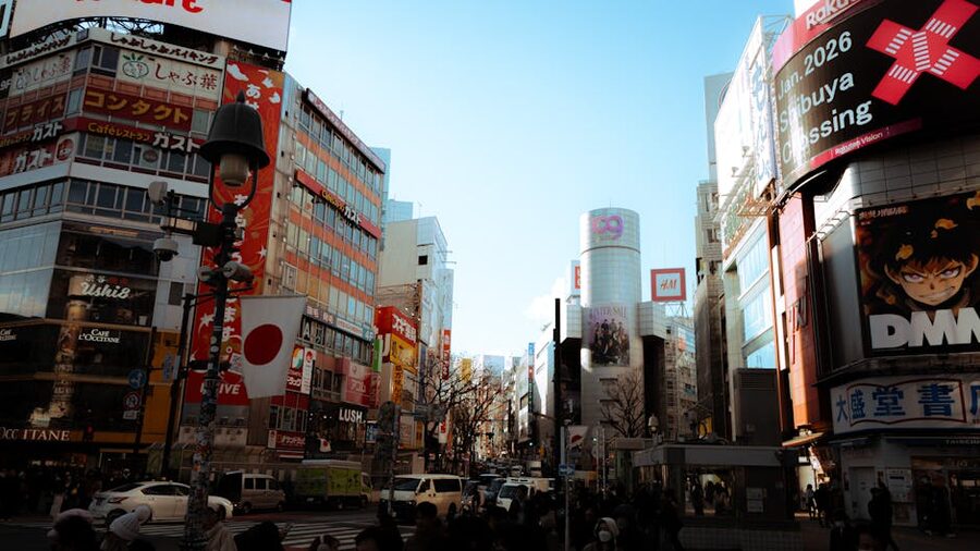 Shibuya Crossing daytime with colorful advertisements