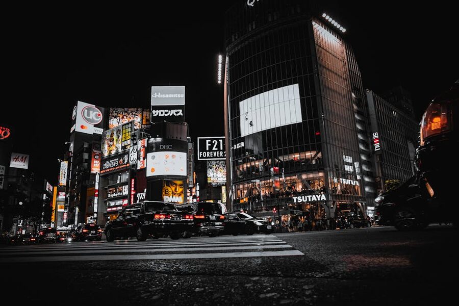 Wide night view of Shibuya Crossing Tokyo with crowds and billboards