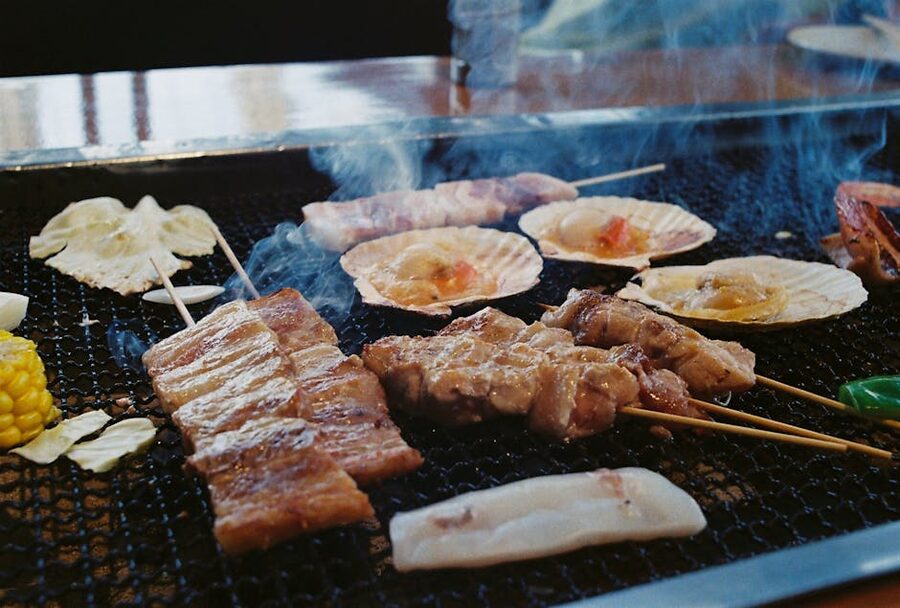 Grilled Japanese skewers sizzling on an open barbecue