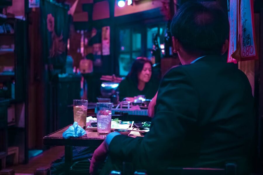 A diner enjoying izakaya food in a Tokyo restaurant at night