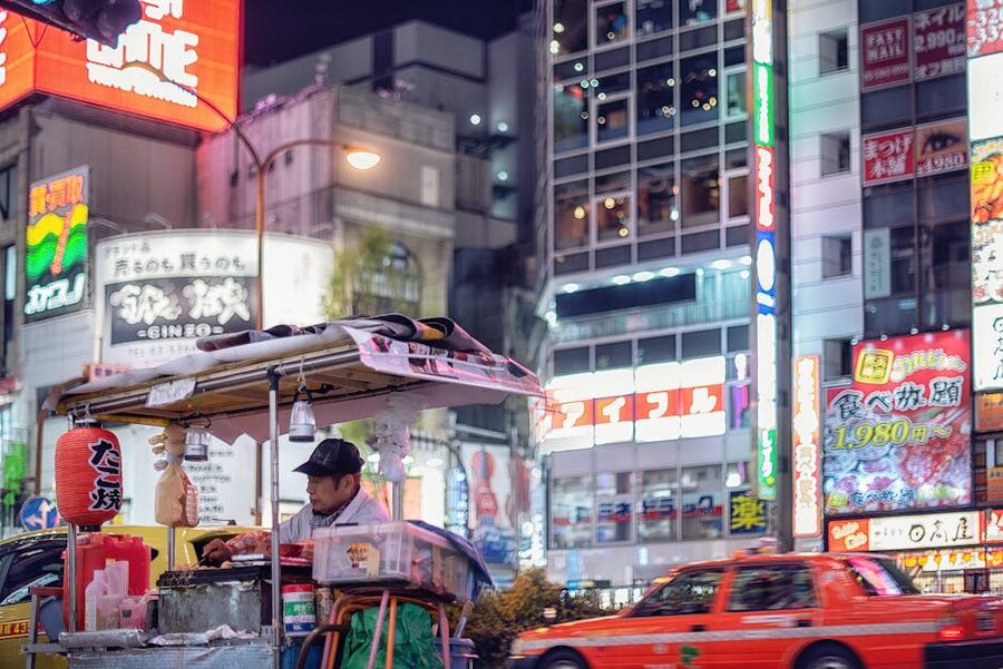 Tokyo street vendor under neon lights at night