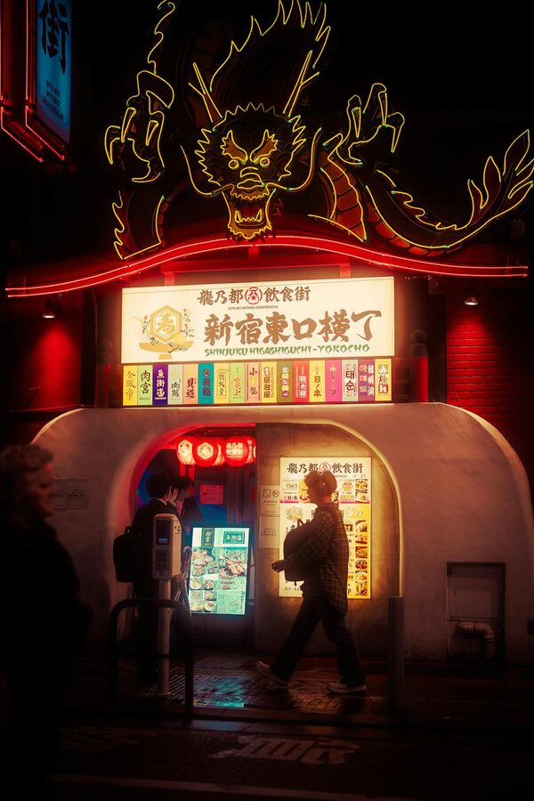 Neon-lit dragon sign in Shinjuku district Tokyo at night