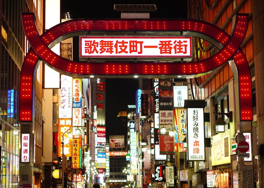 Shinjuku street signs glowing at night