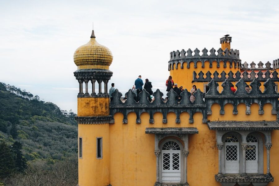 Pena Palace yellow towers with visitors on the terrace Sintra
