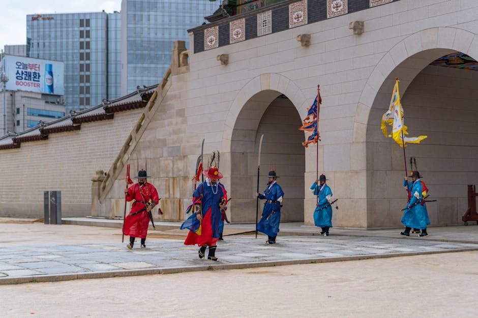 Traditional Korean guards in ceremonial dress at palace gate