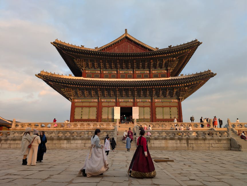 Visitors in hanbok at Gyeongbokgung Palace at sunset