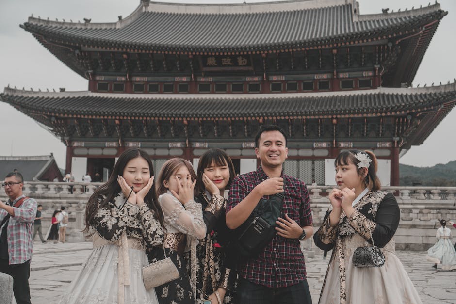 Tourists posing in front of Gyeongbokgung Palace