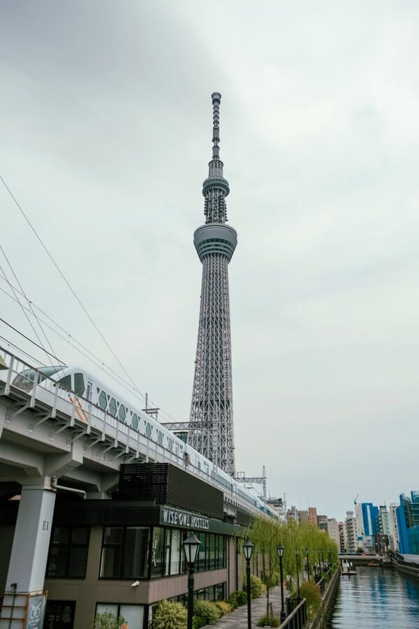 View of the iconic Tokyo Skytree towering beside a canal in Sumida