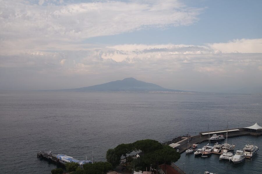 Sorrento Harbor with Mount Vesuvius in the distance under a peaceful sky
