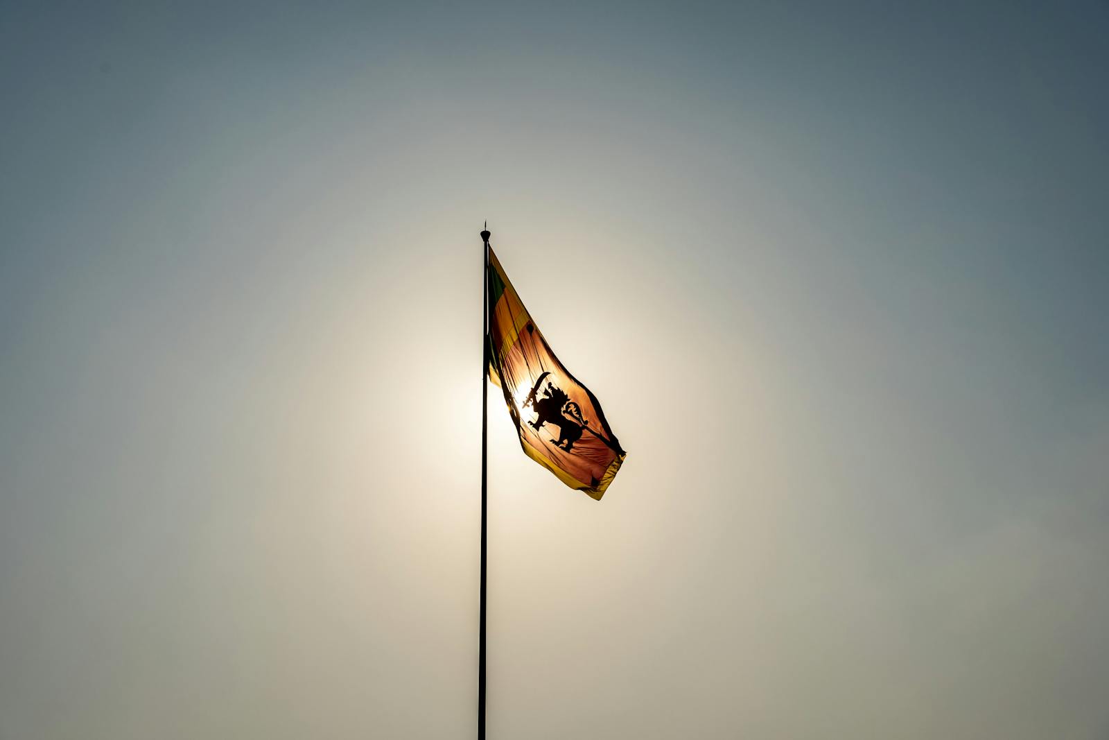 Sri Lankan flag waving in the wind against a clear blue sky in Colombo