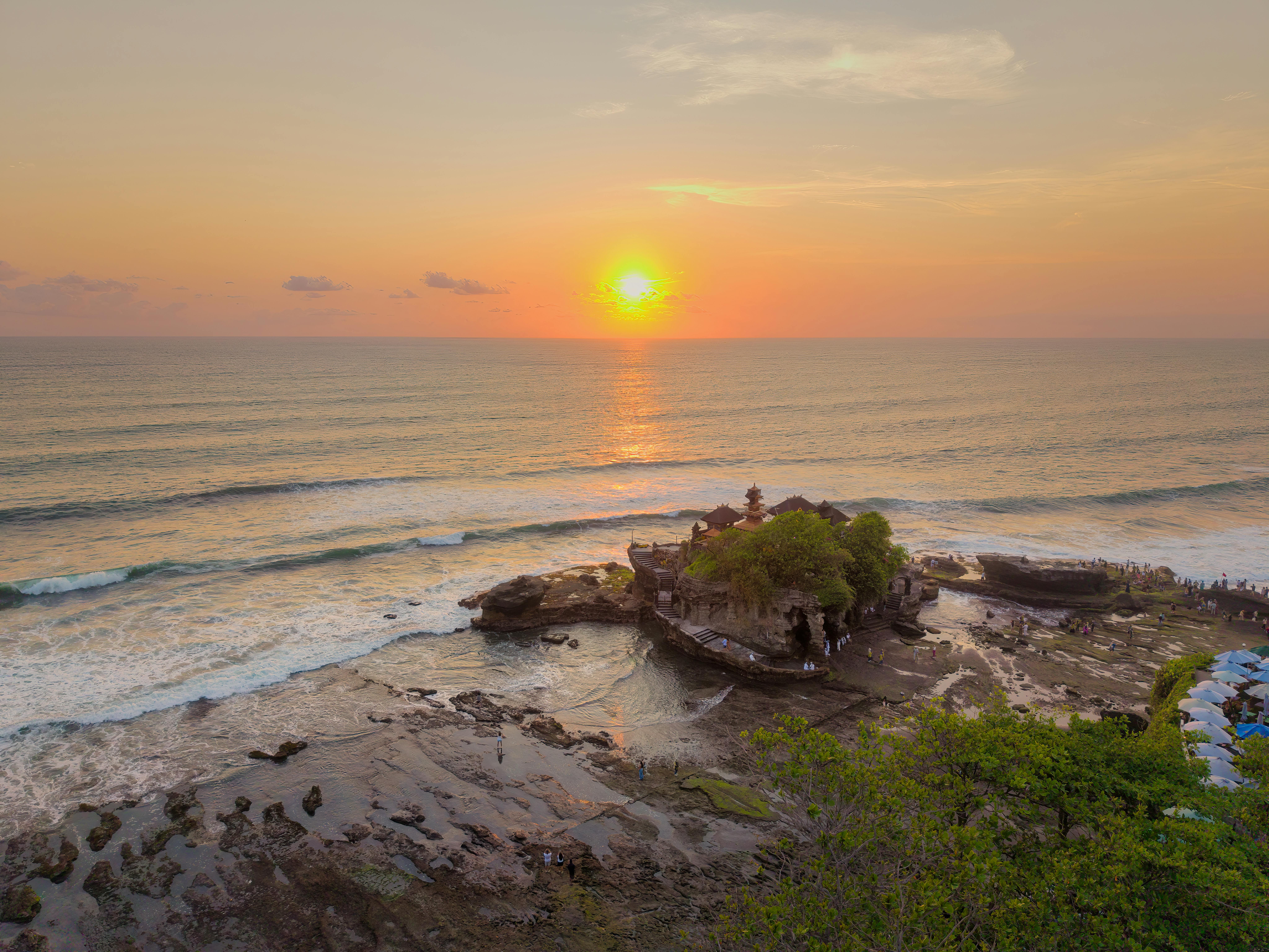 Sunset view of Tanah Lot Temple surrounded by the ocean