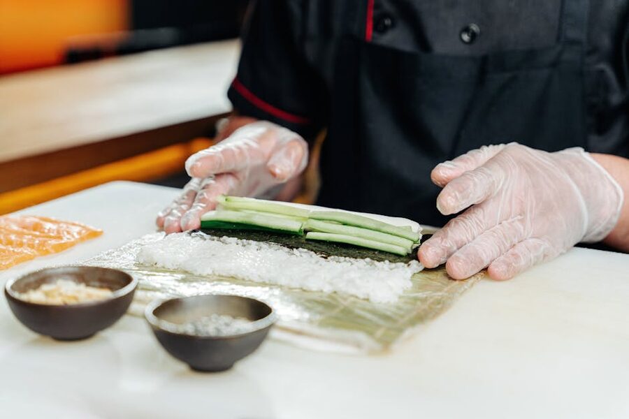 Chef preparing mango cucumber sushi roll