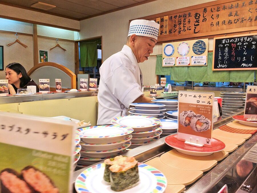 Sushi chefs in a conveyor belt sushi restaurant in Kyoto