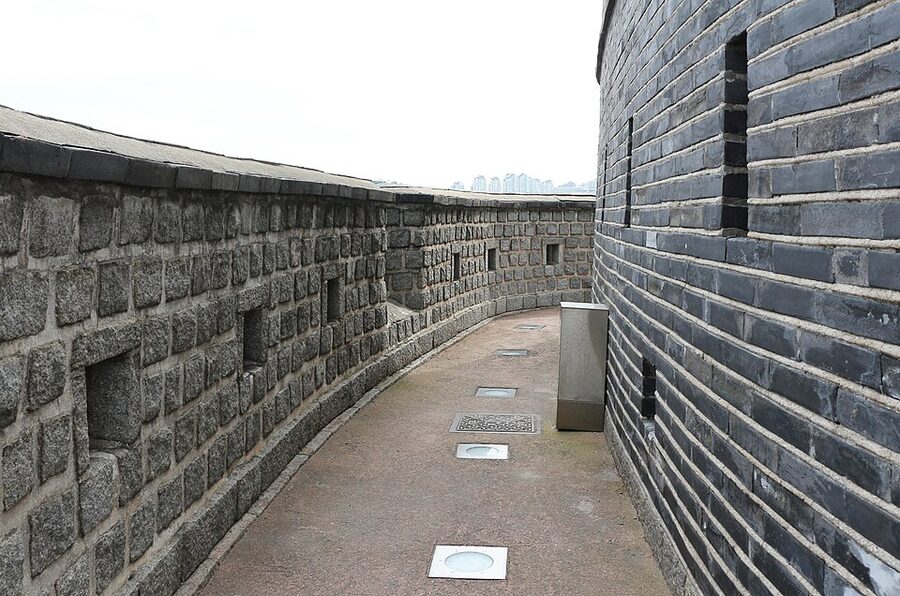 Stone section of Hwaseong Fortress wall with trees