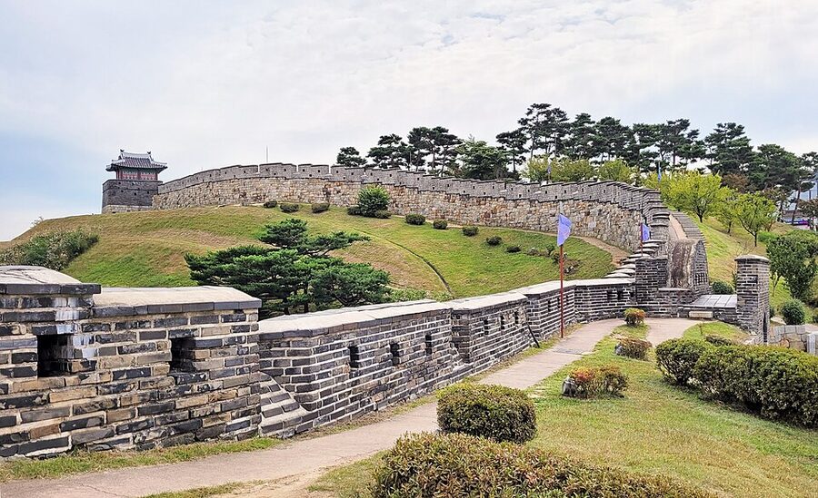 Stone wall section of Hwaseong Fortress curving along a ridge in Suwon