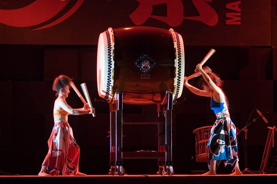 Taiko drummers in traditional attire performing on stage