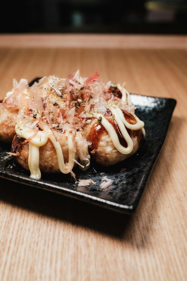 Golden takoyaki balls topped with mayonnaise and bonito flakes