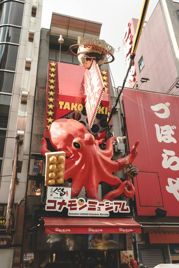 Colorful giant octopus sign above a takoyaki shop in Dotonbori Osaka