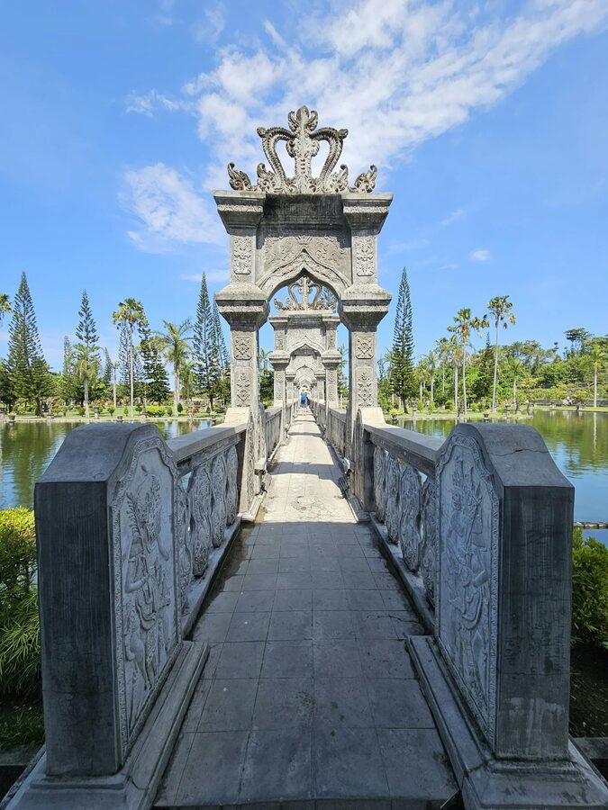 Stone footbridge and ornamental architecture at Taman Ujung Water Palace in Bali