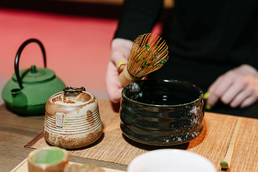 Experience the art of matcha tea preparation using traditional bamboo whisk