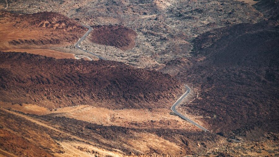 Aerial view of winding Teide road through volcanic terrain