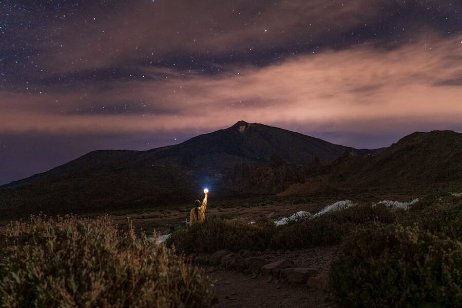 Stargazer with flashlight under Tenerife stars