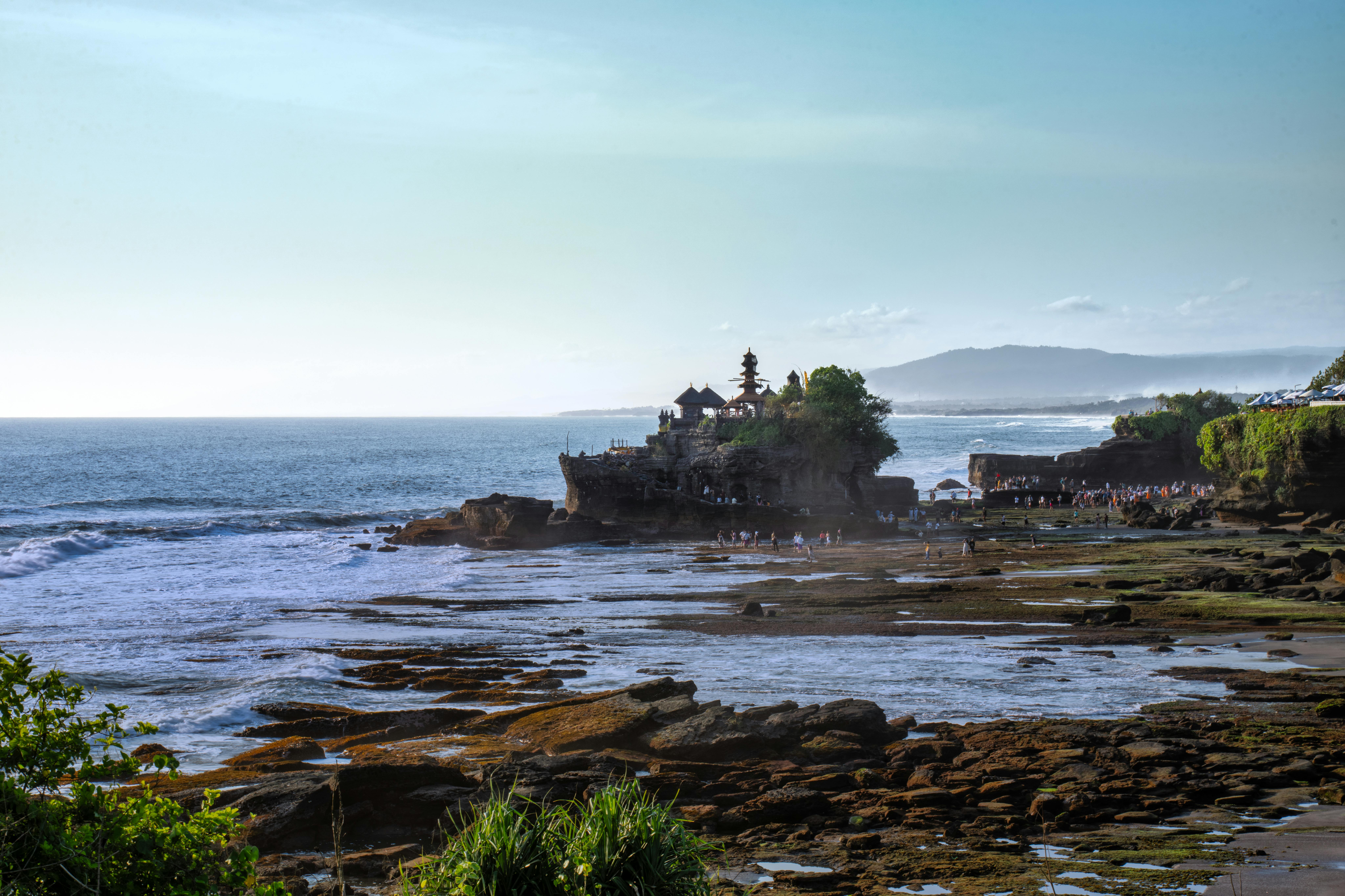 Tanah Lot Temple at late afternoon on the rocky Bali coastline