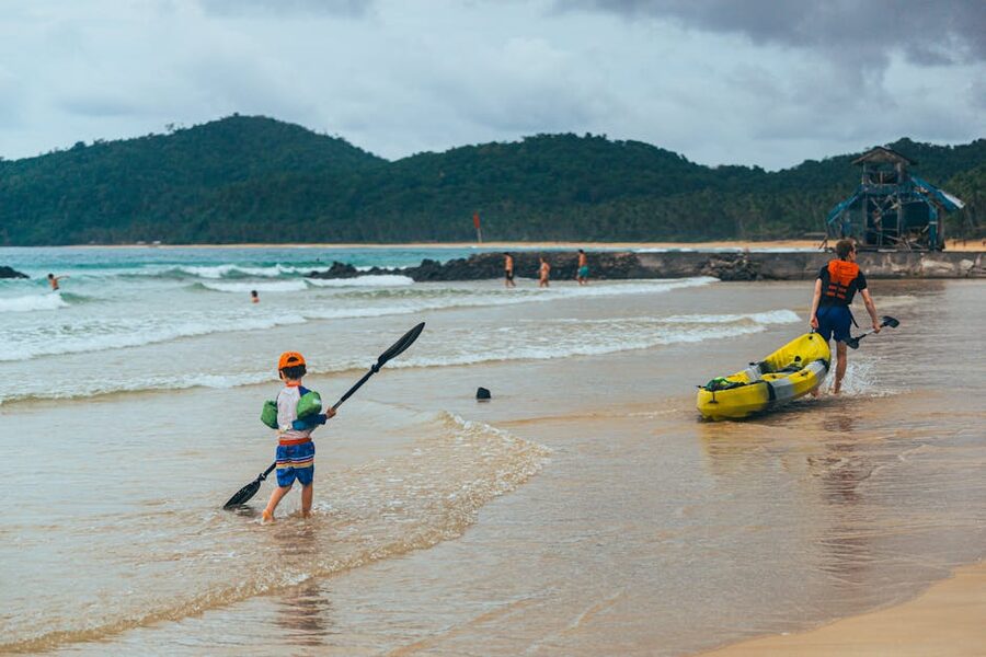 Family preparing for a beach kayaking trip