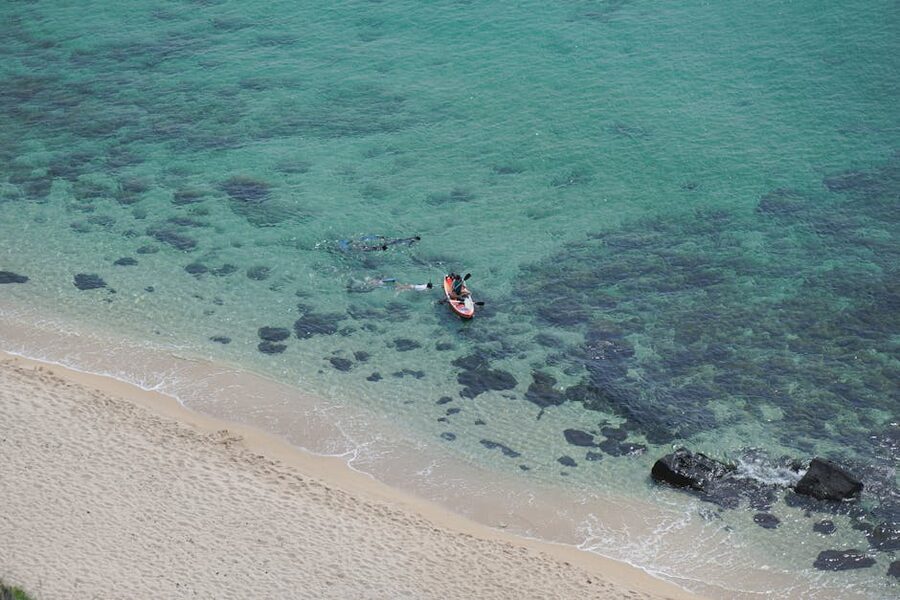 Aerial view of snorkellers and a kayak in turquoise water, Tenerife coast