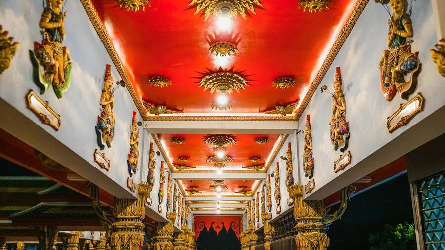 Colorful sculptures and golden decor inside a Thai Buddhist temple