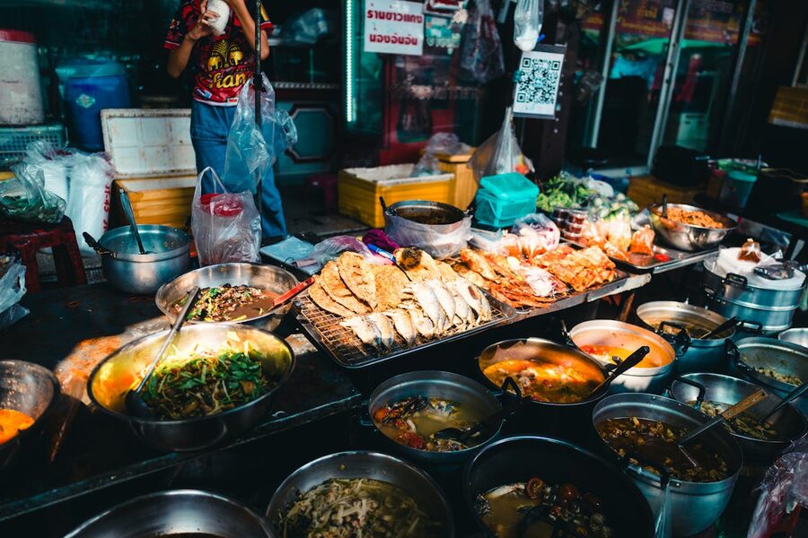 Authentic Thai street food stalls showing diverse dishes at a Bangkok market