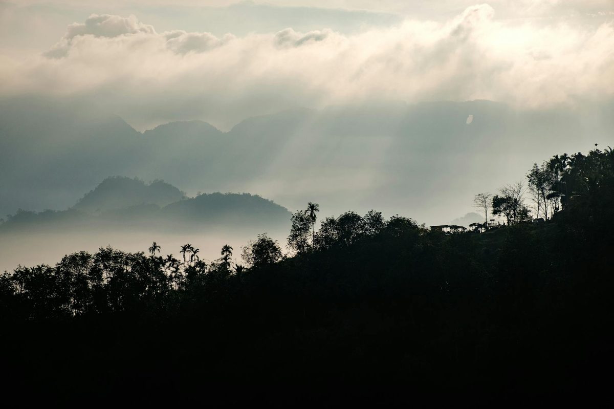 Silhouette of mountains and trees at dusk in Thailand