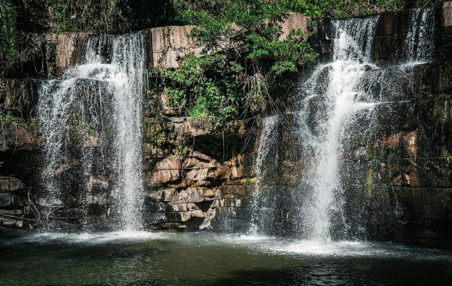 Twin waterfalls cascading in a lush Thai forest landscape
