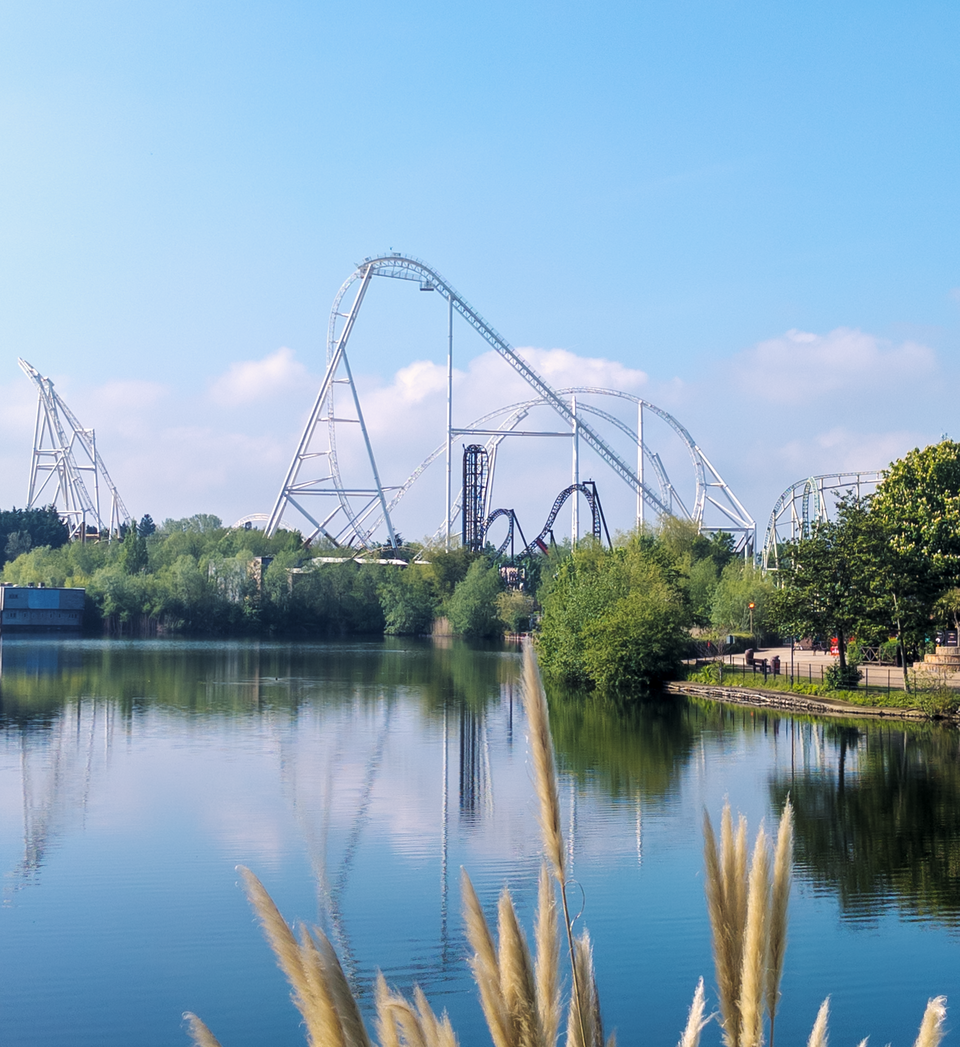 Hyperia and Saw The Ride coasters viewed from across the lake at Thorpe Park