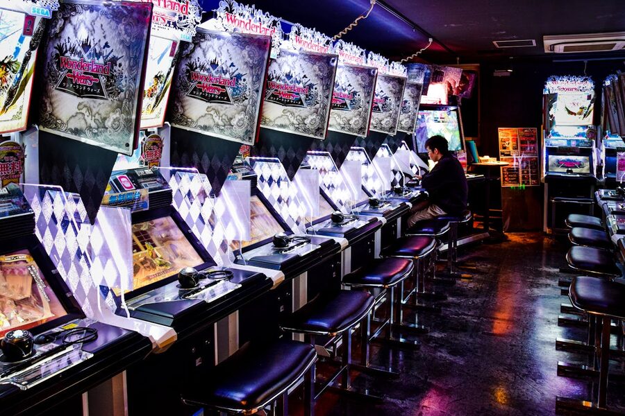 Man playing a game machine in a Tokyo arcade
