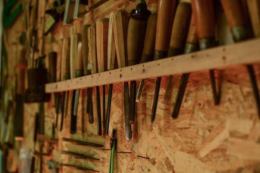 Wood carving chisels organized on a workshop bench