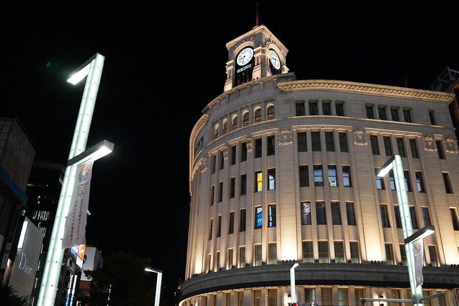 Ginza clock tower illuminated at night with city lights