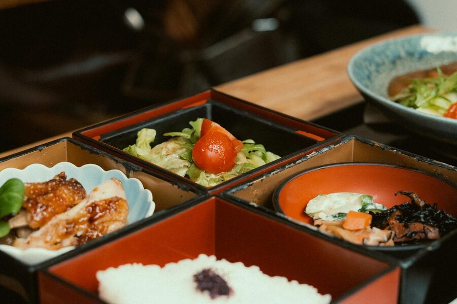 Elegant Japanese bento box with diverse dishes beautifully arranged