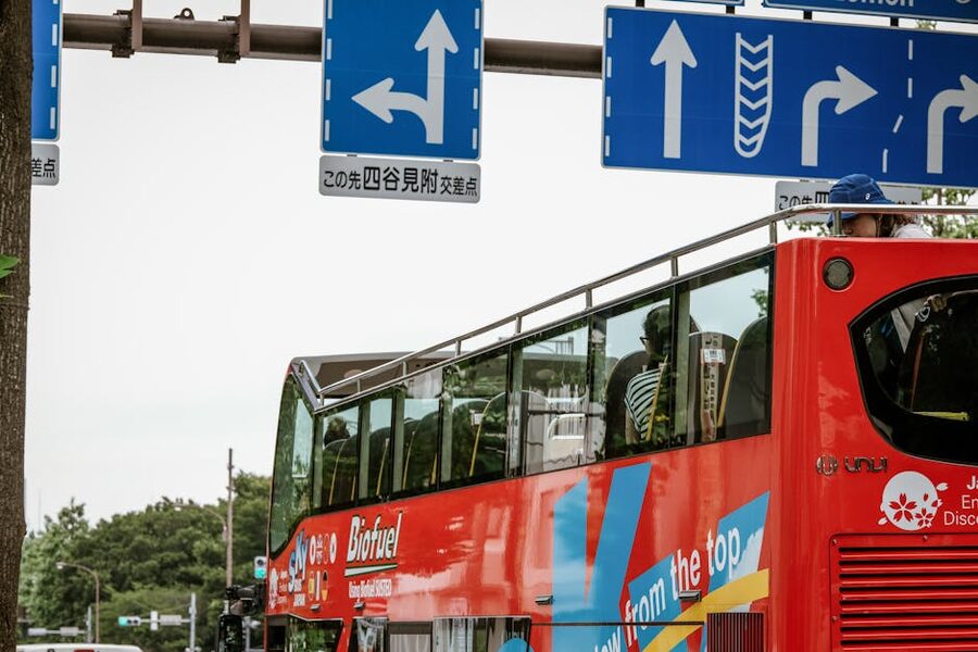 Open-top sightseeing bus with passengers in Shinjuku Tokyo