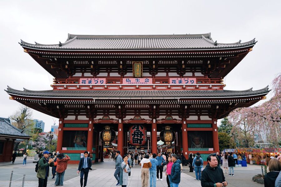 Visitors walking through Hozomon Gate at Senso-ji Temple