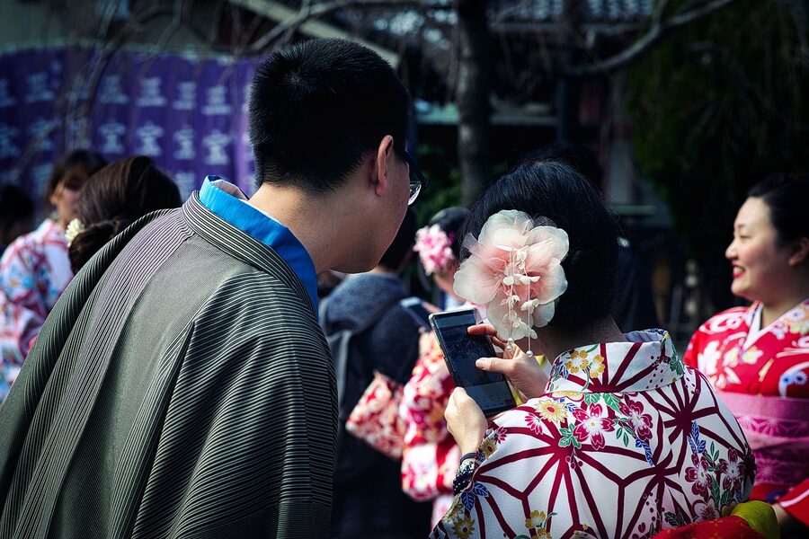 Couple in kimono with flower hair ornaments viewed from behind in Tokyo